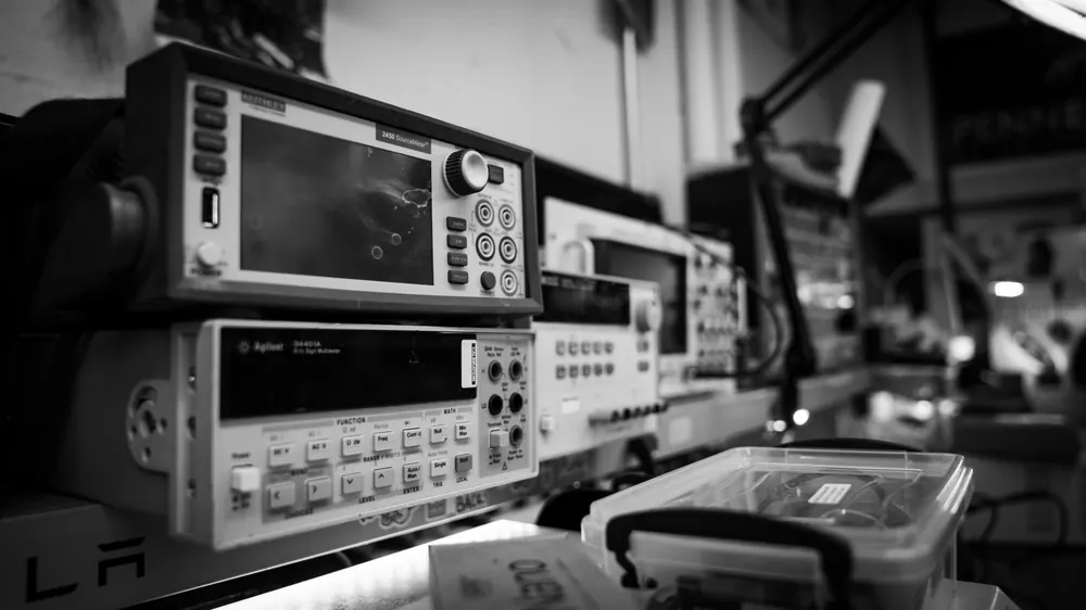 Black and white photo of test equipment on the electronics bench