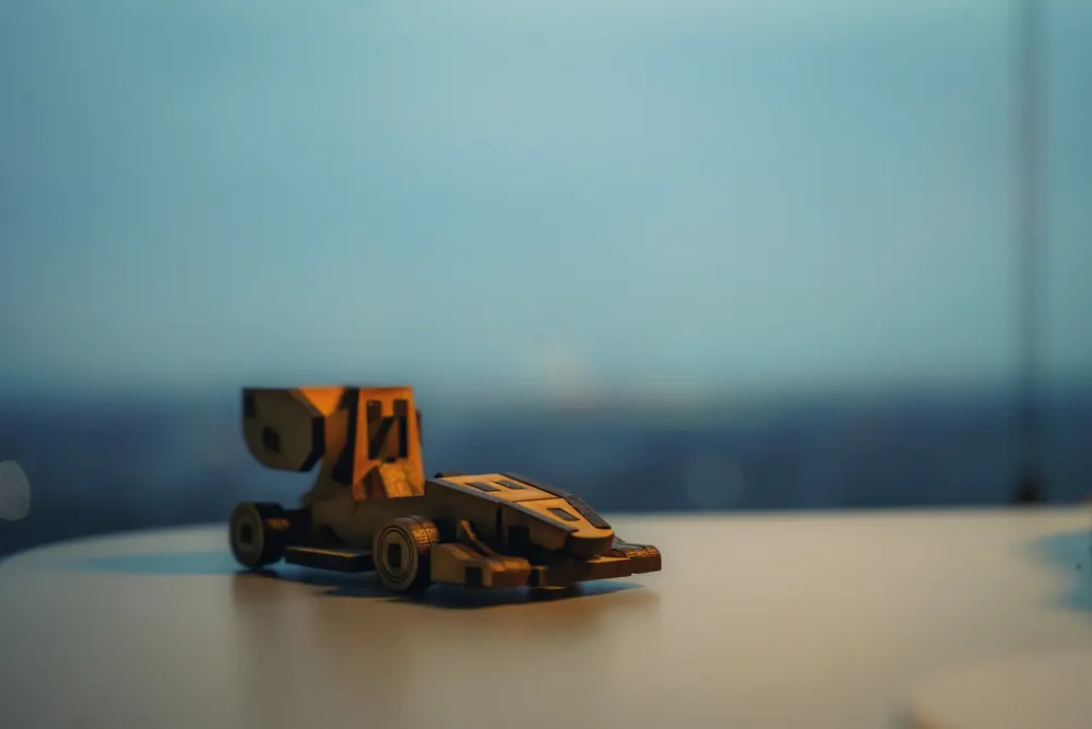A small wooden model of the car on a table