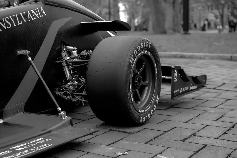 Black and white close-up of the bodywork and front wheel